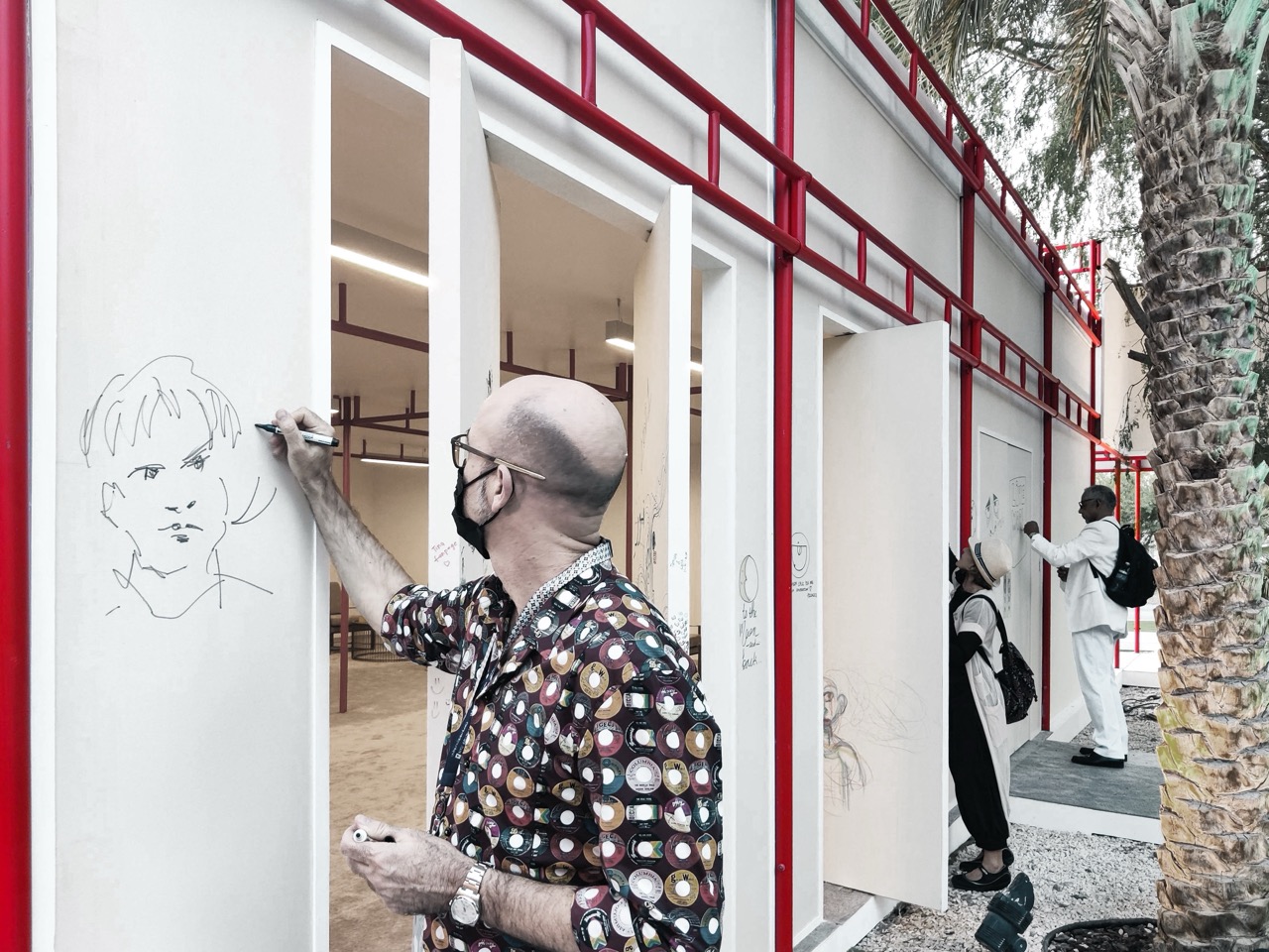 Visitors leaving their mark on Impermanence's canvas facade